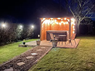 a table and chairs in a backyard at night at Herrock View in Evenjobb