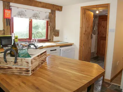 a kitchen with a wooden counter top and a sink at Broughton Stables in Montgomery