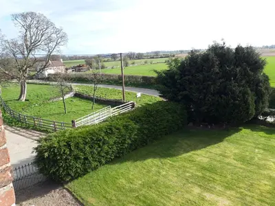 an aerial view of a park with bushes and a fence at Upper Eyton Farmhouse B&B in Shrewsbury