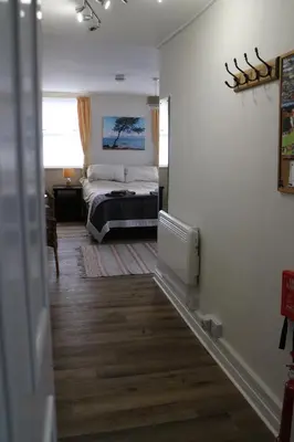 a bedroom with a bed in the corner of a room at The Holt in Llangollen