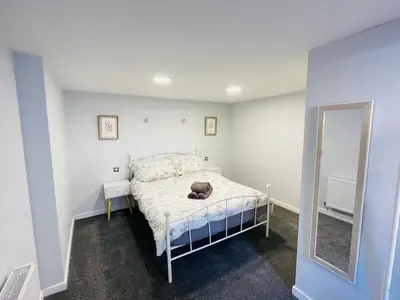 a bedroom with a bed with a dog laying on it at 10 Bromleys Court in Church Stretton