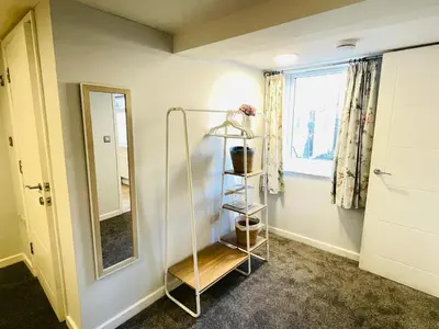 a bathroom with a glass shelf and a mirror at 10 Bromleys Court in Church Stretton