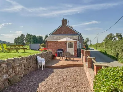 a brick house with a table and chairs and a stone wall at Conquer Hall in Montgomery