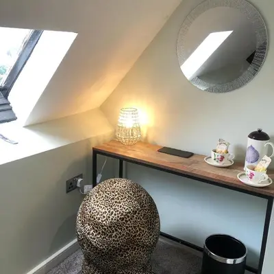 a room with a table with a chair and a mirror at Mount Street House in Brecon