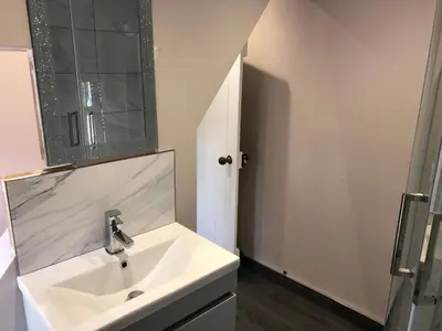 a white bathroom with a sink and a mirror at Mount Street House in Brecon