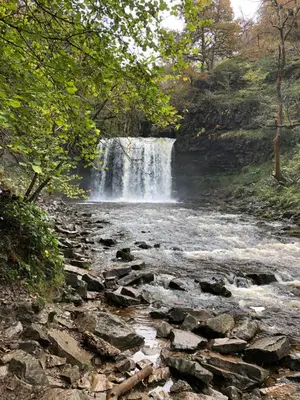 a waterfall in the middle of a river at Mount Street House in Brecon