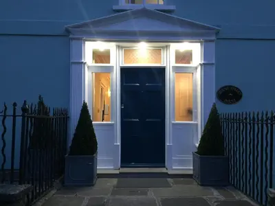 a blue house with a door with lights on it at Mount Street House in Brecon