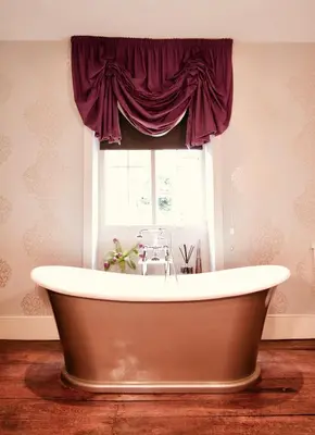 a bath tub in a room with a window at The Old Stores in Montgomery