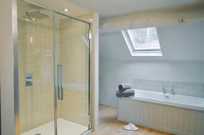 a bathroom with a shower and a bath tub at The Old Stores in Montgomery