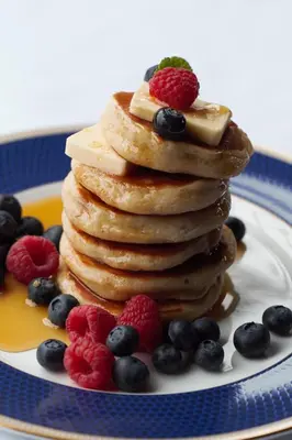 a stack of pancakes with berries on a plate at The Old Stores in Montgomery