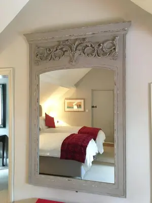 a mirror in a bedroom with a bed in it at The Old Stores in Montgomery