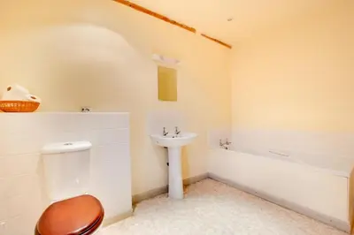 a bathroom with a sink and a toilet and a bath tub at Pandy Barn Berriew in Welshpool