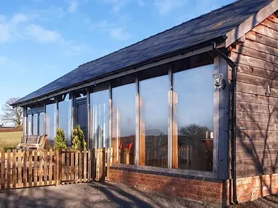 a house with large windows on the side of it at Oak View in Highgate