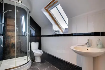 a bathroom with a toilet and a sink and a shower at 3 Bed in Tywyn oc-bow170 in Tywyn