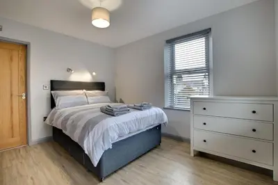 a bedroom with a bed and a dresser and a window at 5 Bed in Bala oc-bow163 in Bala