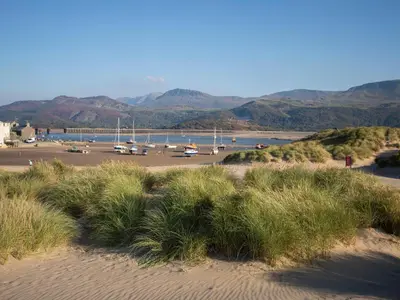 a view of a beach with boats in the water at Glan Meon Cottage in Barmouth