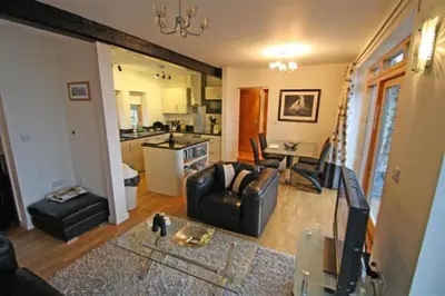 a living room with a couch and a table at The Old Stables Aberdyfi apartment 3 in Aberdyfi
