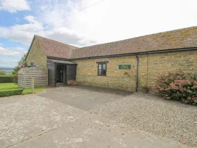 a brick house with a driveway in front of it at The Onibury in Craven Arms