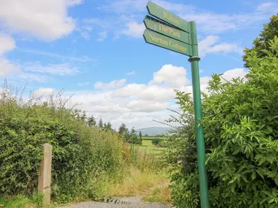 a green street sign on the side of a road at The Onibury in Craven Arms