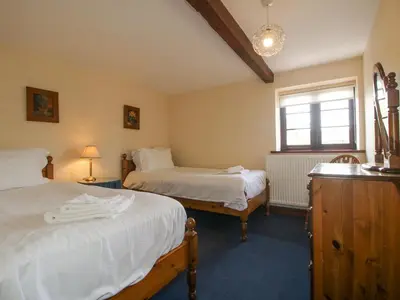 a bedroom with two beds and a window at The Walton in Craven Arms