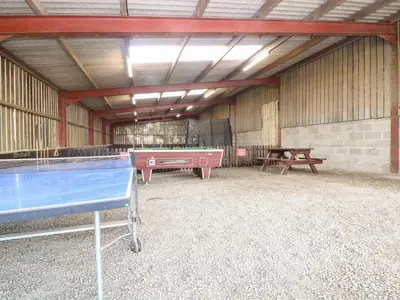 a pool table in a barn with a ping pong ball at The Walton in Craven Arms