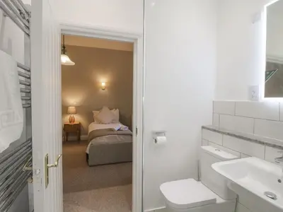 a bathroom with a sink and a bed in a room at The Park in Craven Arms