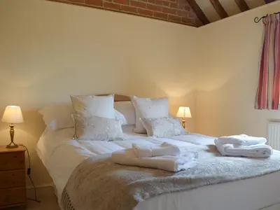 a bedroom with two towels on a bed at Talog Barn-Uk31366 in Tregynon