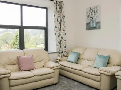 a living room with two couches and a window at The Farm in Presteigne