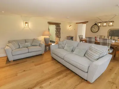 a living room with two couches and a table at Tyn Ffynnon in Dyffryn