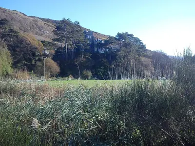a house on top of a hill in a field at Lovely Large home 10 Minute Walk to Barmouth Beach in Barmouth