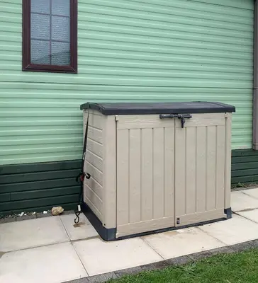 a box sitting on a sidewalk in front of a building at 157 Amour Caravan in Tywyn