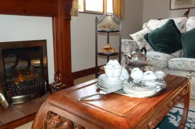 a living room with a coffee table with dishes on it at Willow Cottage in North Lydbury