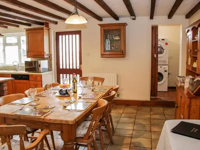 a kitchen with a large wooden table and chairs at Bryn Celyn in Oswestry