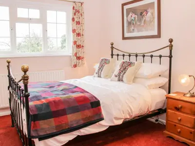 a bedroom with a bed and a window at Bryn Celyn in Oswestry