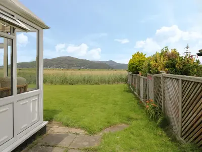 a view from the porch of a house with a yard at Hafod-y-Gors in Fairbourne