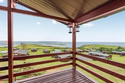 a view from the porch of a house with a view of the ocean at The Look Out in Aberdyfi