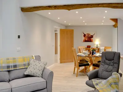 a living room with a couch and a table at Cwm Dulas in Llanddewi-Brefi