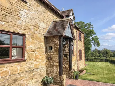 an external view of a stone building with a window at Wilstone Cottage in Church Stretton