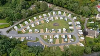an aerial view of a parking lot with cars at Shepherds Hut at Wern Mill in New Quay