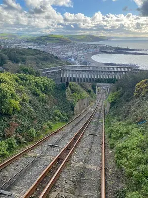 a train track with a bridge in the distance at Chalet 5 Clarach Bay in Aberystwyth