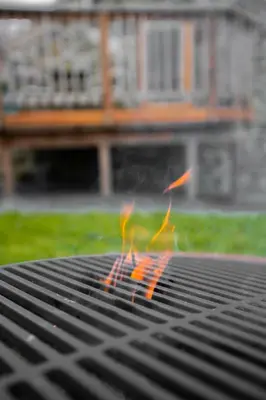 a grilling grate with orange flames on it at Snowdonia Hideaway in Tywyn