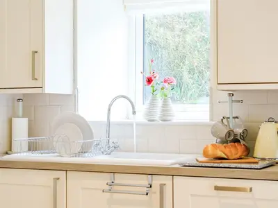 a kitchen counter with a sink and a window at Ty Draenog - Uk31653 in New Quay