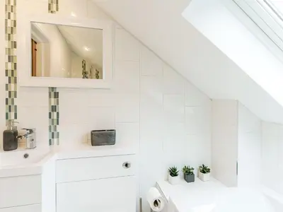 a white bathroom with a sink and a mirror at Ty Draenog - Uk31653 in New Quay