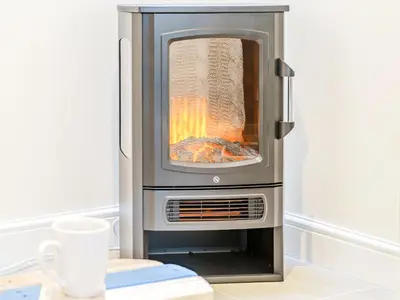 an oven with a fire inside of it at Ty Draenog - Uk31653 in New Quay
