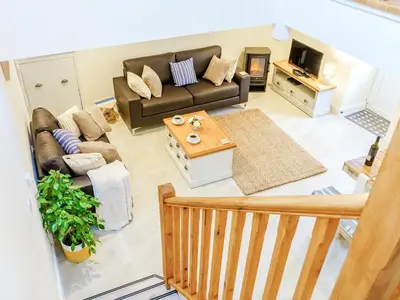a living room with a couch and a table at Ty Arth - Uk31652 in New Quay