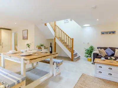 a living room with a table and a couch at Ty Arth - Uk31652 in New Quay