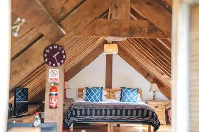 a bedroom with a bed in a attic at the garden room in Shrewsbury