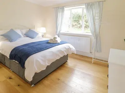 a bedroom with a bed with a teddy bear on it at Hendre in Oswestry