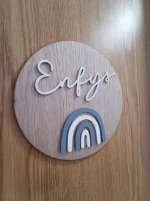 a sign with a rainbow on a wooden wall at Eldon Row - Stylish Character Apartments - Central Location 1 & 2 bed available in Dolgellau