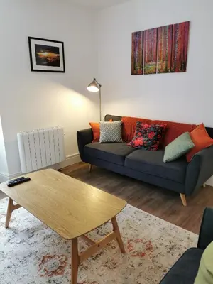 a living room with a couch and a coffee table at Eldon Row - Stylish Character Apartments - Central Location 1 & 2 bed available in Dolgellau